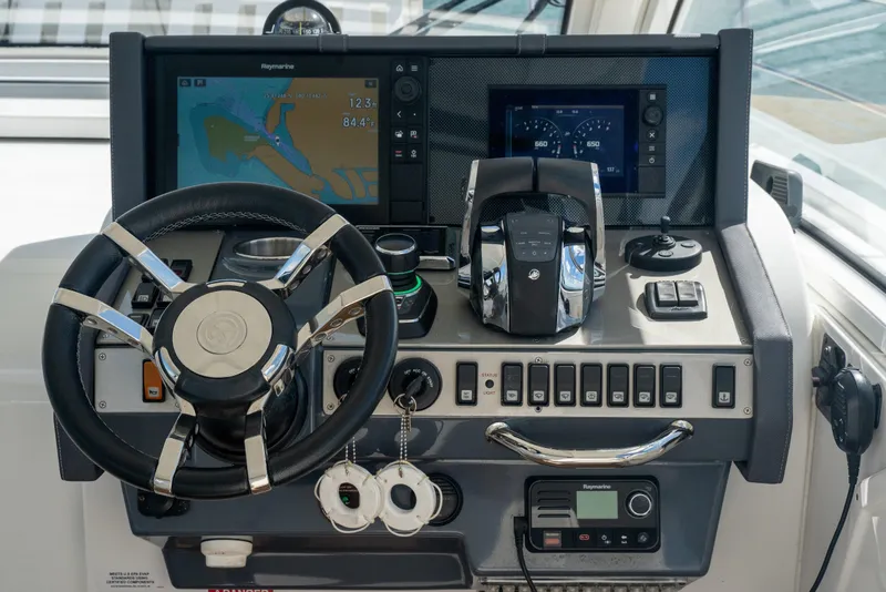 Slide: The Image of Helm of 2018 Cruisers Yachts 390 Express Coupe with navigation and control systems. - 38