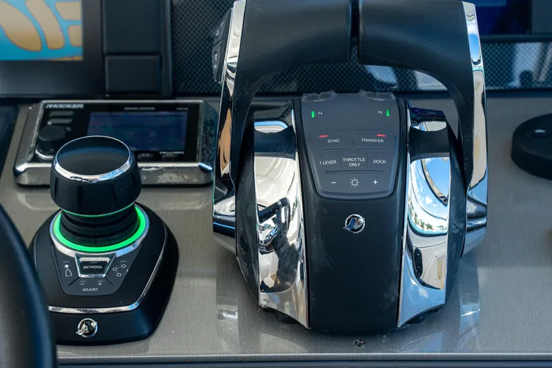 Slide: The Image of Control panel of 2018 Cruisers Yachts 390 Express Coupe with joystick and throttle controls. - 40