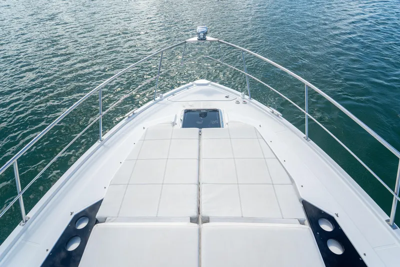 Slide: The Image of 2018 Cruisers Yachts 390 Express Coupe bow view on water, showcasing sleek design. - 48