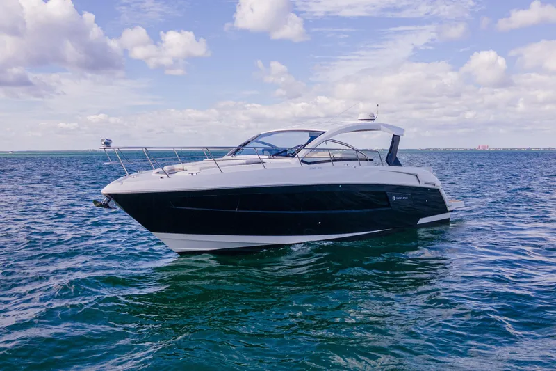 Slide: The Image of 2018 Cruisers Yachts 390 Express Coupe on open water under blue sky. - 5