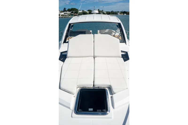 Slide: The Image of 2018 Cruisers Yachts 390 Express Coupe with sunbathing deck, docked by the water. - 50