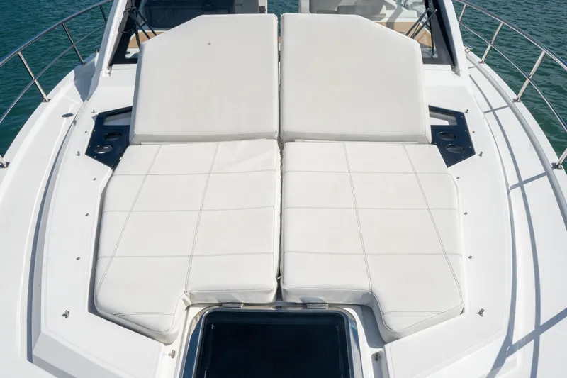 Slide: The Image of 2018 Cruisers Yachts 390 Express Coupe sunpad on deck, surrounded by ocean. - 51