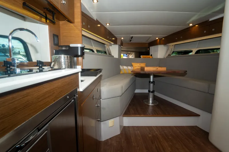 Slide: The Image of Interior of 2018 Cruisers Yachts 390 Express Coupe with modern kitchen and cozy seating area. - 52