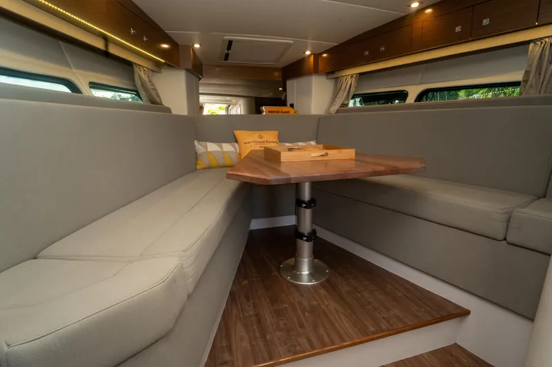 Slide: The Image of Interior of 2018 Cruisers Yachts 390 Express Coupe with cozy seating and wooden table. - 53