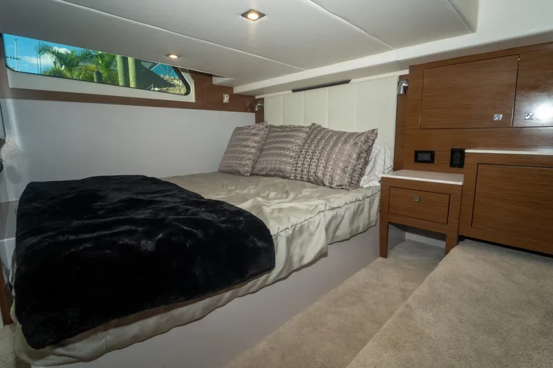 Slide: The Image of Luxurious cabin interior of 2018 Cruisers Yachts 390 Express Coupe with cozy bedding. - 57