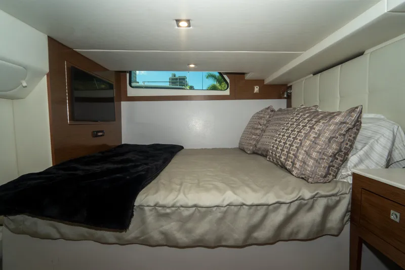 Slide: The Image of Luxurious cabin interior of 2018 Cruisers Yachts 390 Express Coupe with cozy bedding. - 59