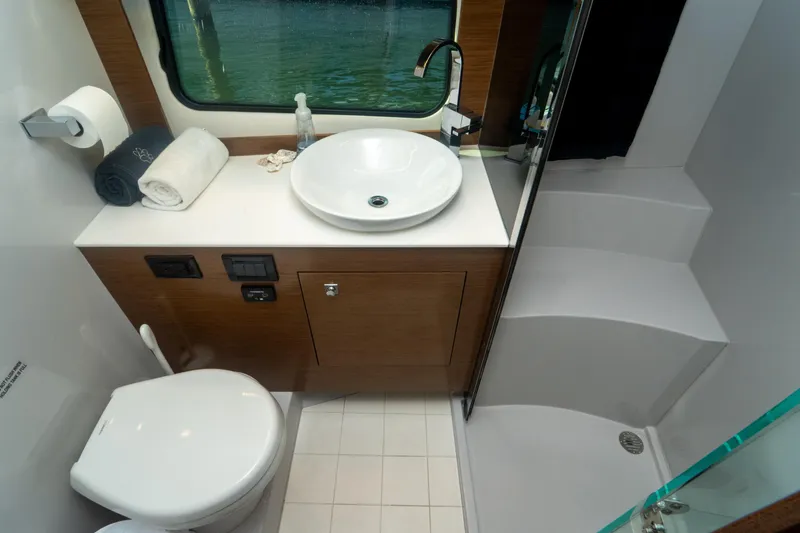 Slide: The Image of Luxurious bathroom in 2018 Cruisers Yachts 390 Express Coupe with modern fixtures and elegant design. - 60