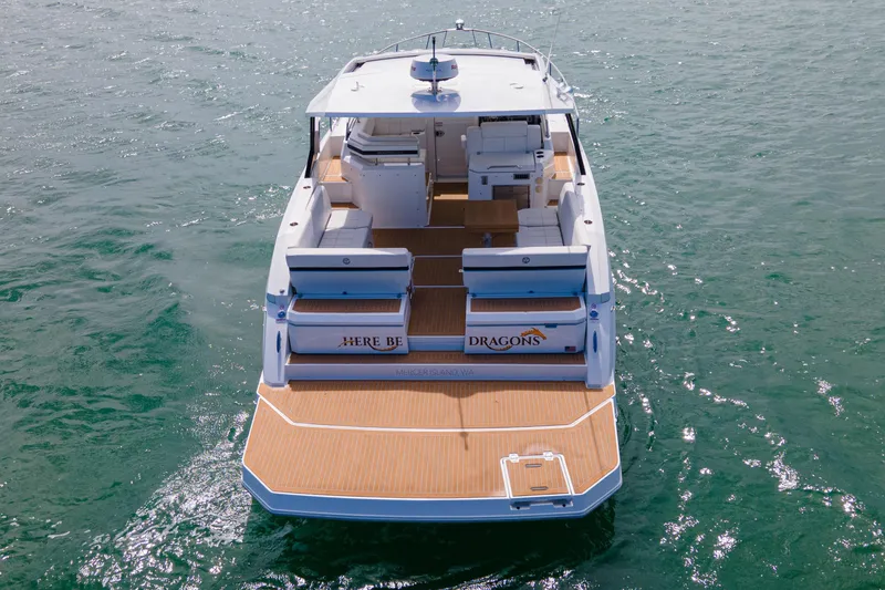 Slide: The Image of 2018 Cruisers Yachts 390 Express Coupe on water, rear view, spacious deck. - 7