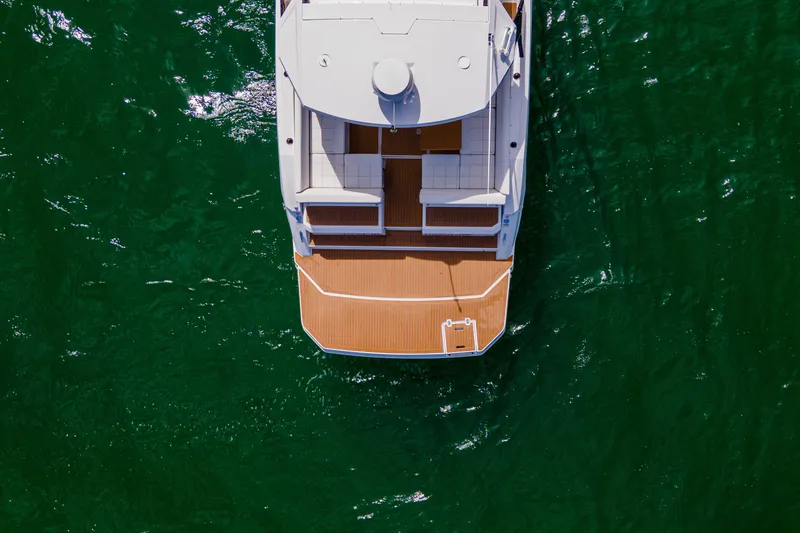 Slide: The Image of Aerial view of 2018 Cruisers Yachts 390 Express Coupe on green water. - 8