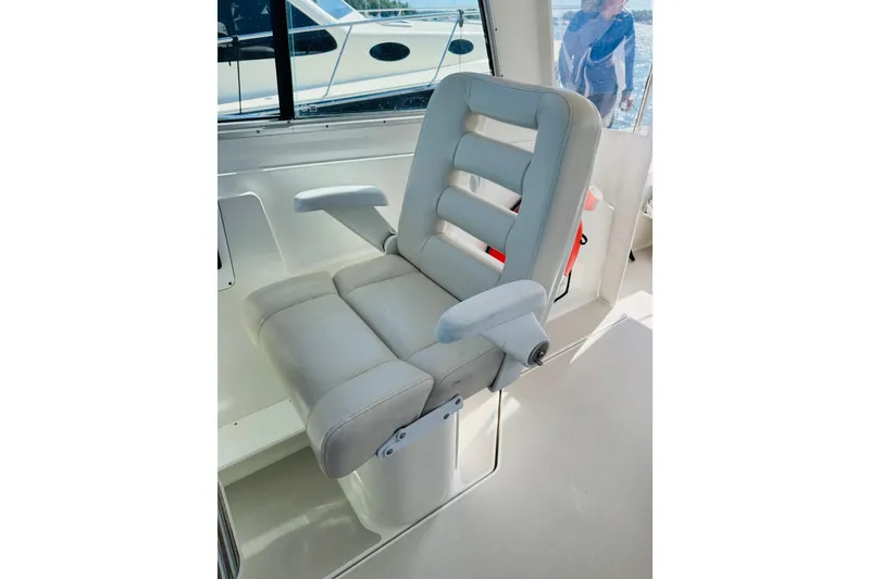 Slide: The Image of Captain's chair on a 2007 Back Cove 29 boat, featuring cushioned armrests and sleek design. - 16