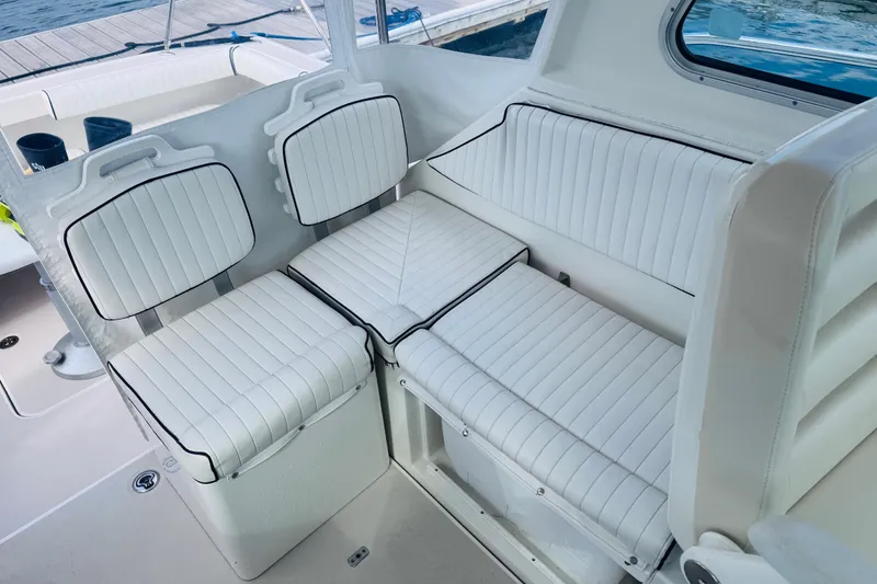 Slide: The Image of 2007 Back Cove 29 boat interior with white cushioned seating and sleek design. - 18