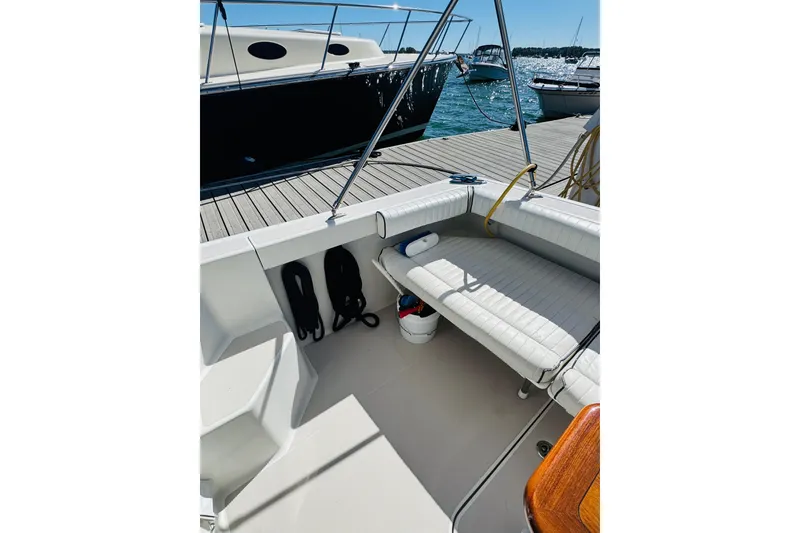 Slide: The Image of 2007 Back Cove 29 boat interior with seating, docked by the water. - 21