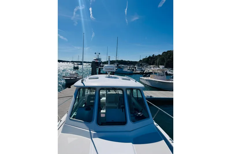 Slide: The Image of 2007 Back Cove 29 boat docked at marina under clear blue sky. - 26