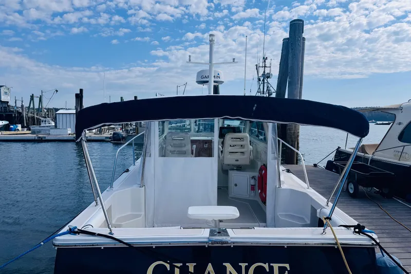 Slide: The Image of 2007 Back Cove 29 boat docked at marina under blue sky. - 38