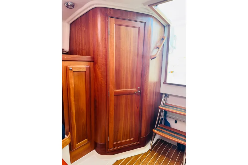 Slide: The Image of Interior of 2007 Back Cove 29 boat with wooden cabinetry and steps. - 8