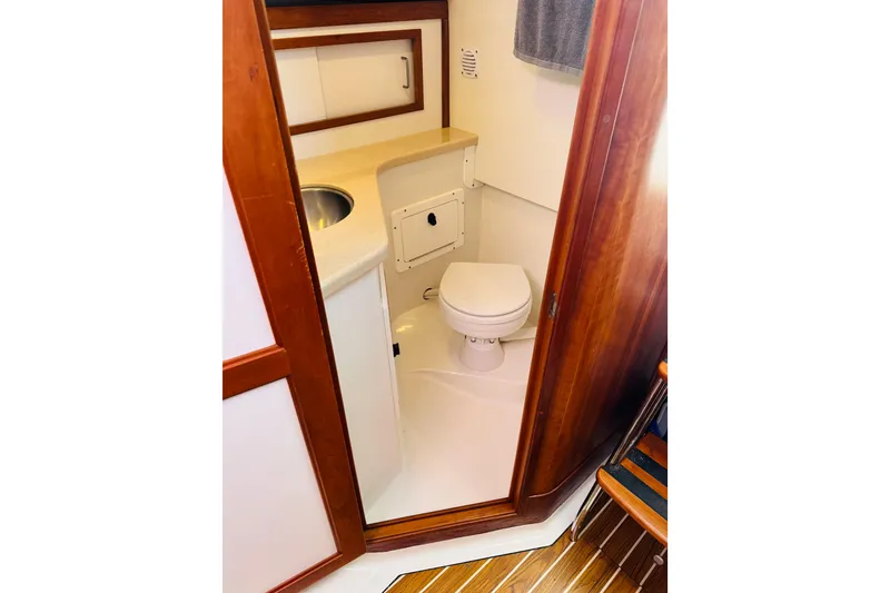 Slide: The Image of 2007 Back Cove 29 boat bathroom with wooden trim and compact design. - 9