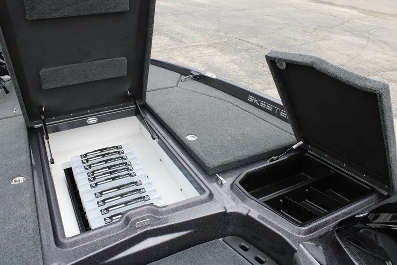 Slide: The Image of 2026 Skeeter ZXE21 boat storage compartments with organized tackle boxes. - 12