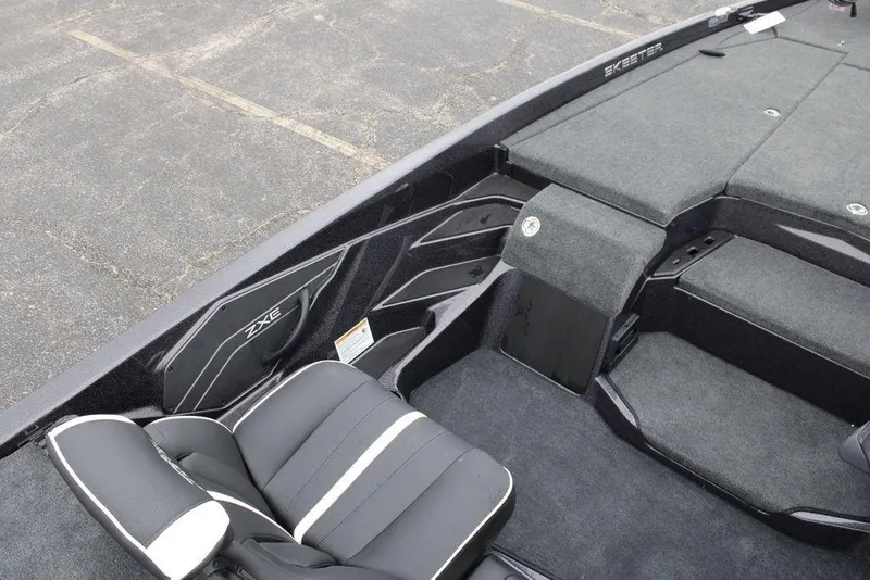 Slide: The Image of 2026 Skeeter ZXE21 boat interior with sleek black seating and spacious deck layout. - 14