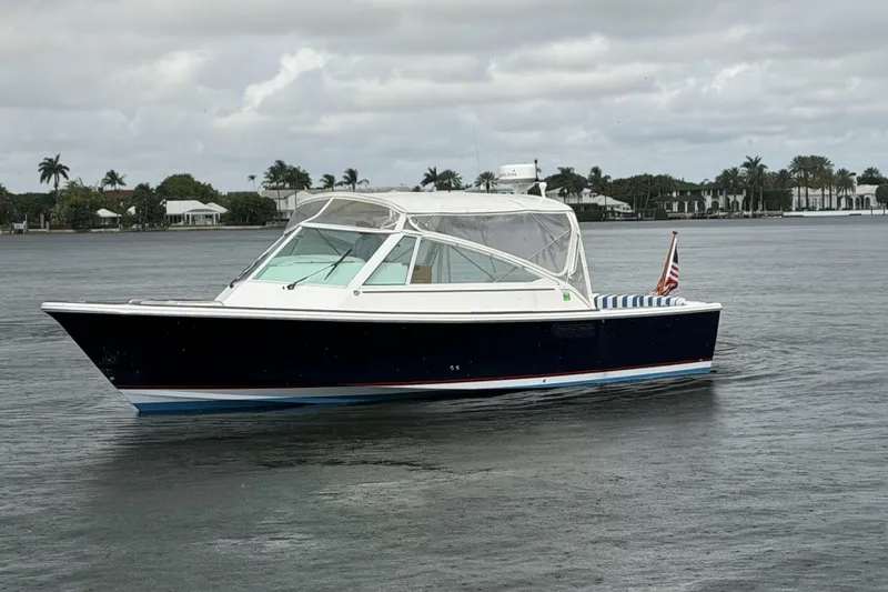 The Image of 2009 Hunt Yachts Harrier 29 cruising on calm waters under cloudy skies. - 0