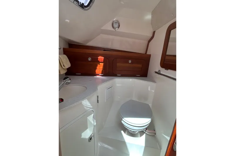 Slide: The Image of 2009 Hunt Yachts Harrier 29 bathroom with wooden cabinets and modern fixtures. - 13