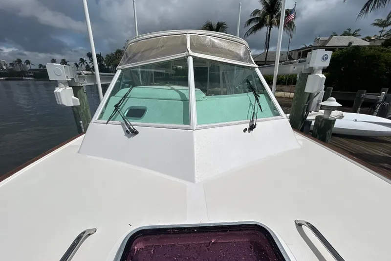 Slide: The Image of 2009 Hunt Yachts Harrier 29 docked, showcasing sleek design and windshield wipers. - 16
