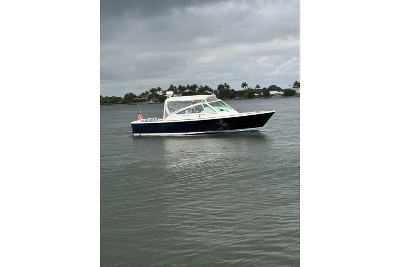 Slide: The Image of 2009 Hunt Yachts Harrier 29 cruising on a calm, overcast waterway. - 2