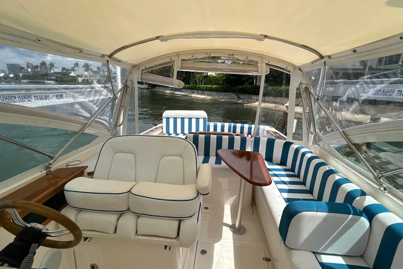 Slide: The Image of 2009 Hunt Yachts Harrier 29 interior with striped seating and wooden accents. - 4