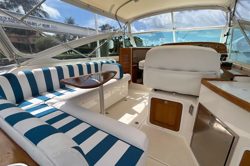 Slide: The Image of 2009 Hunt Yachts Harrier 29 interior with striped seating and wooden accents. - 5