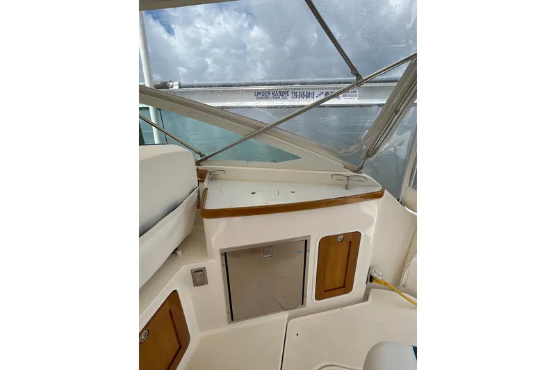 Slide: The Image of 2009 Hunt Yachts Harrier 29 interior with wooden accents and storage compartments. - 6