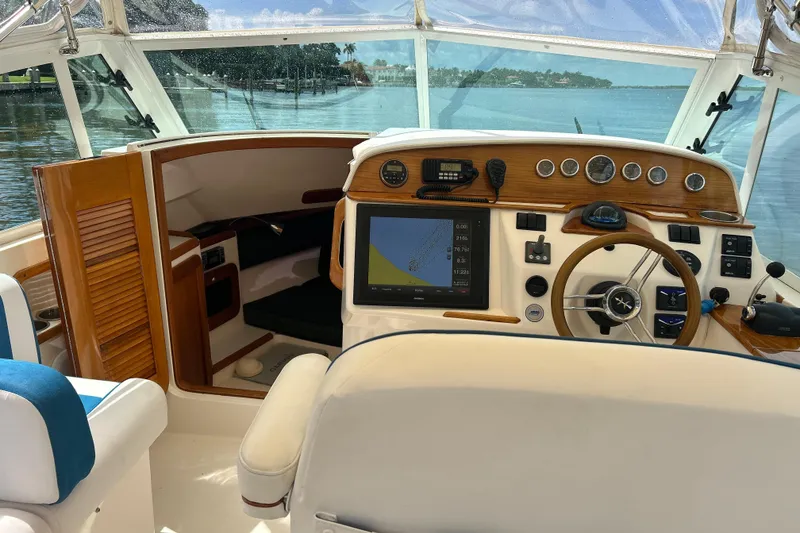 Slide: The Image of Interior view of 2009 Hunt Yachts Harrier 29 helm with wooden dashboard and navigation equipment. - 7