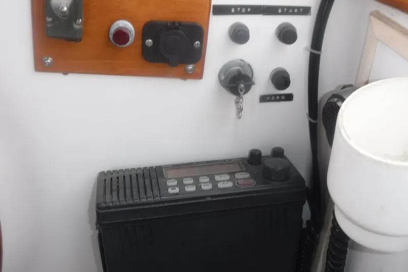 Slide: The Image of Control panel of a 1983 Grand Banks 36 Classic boat with ignition and radio. - 11