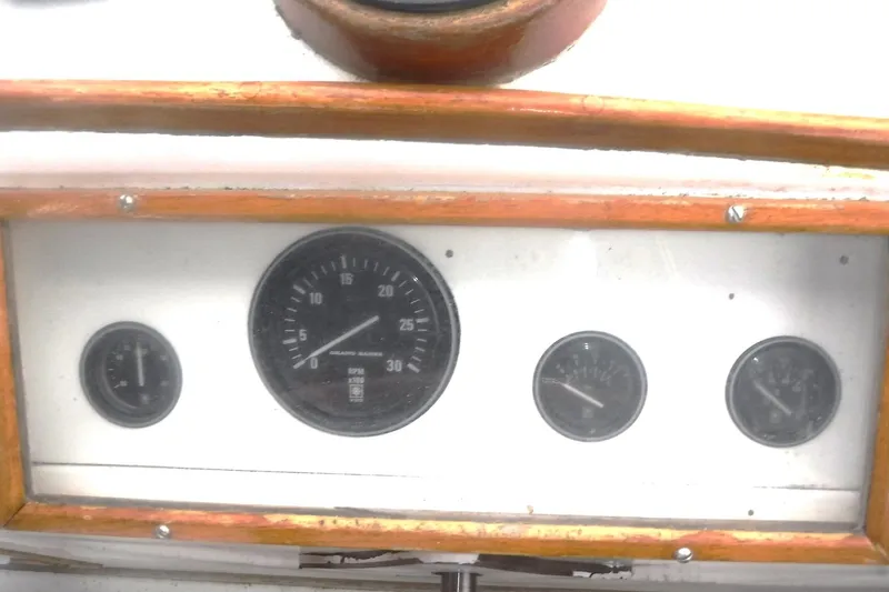 Slide: The Image of Dashboard of a 1983 Grand Banks 36 Classic boat with wooden trim and gauges. - 12