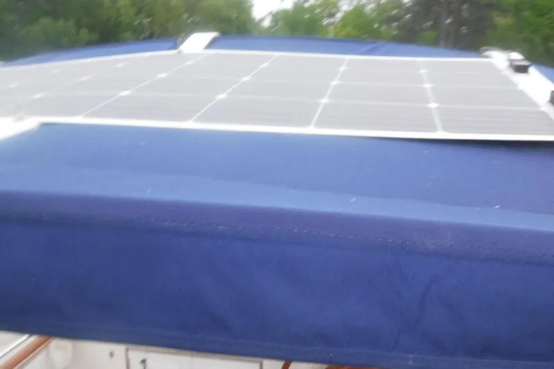 Slide: The Image of 1983 Grand Banks 36 Classic with solar panels on blue canvas cover. - 15