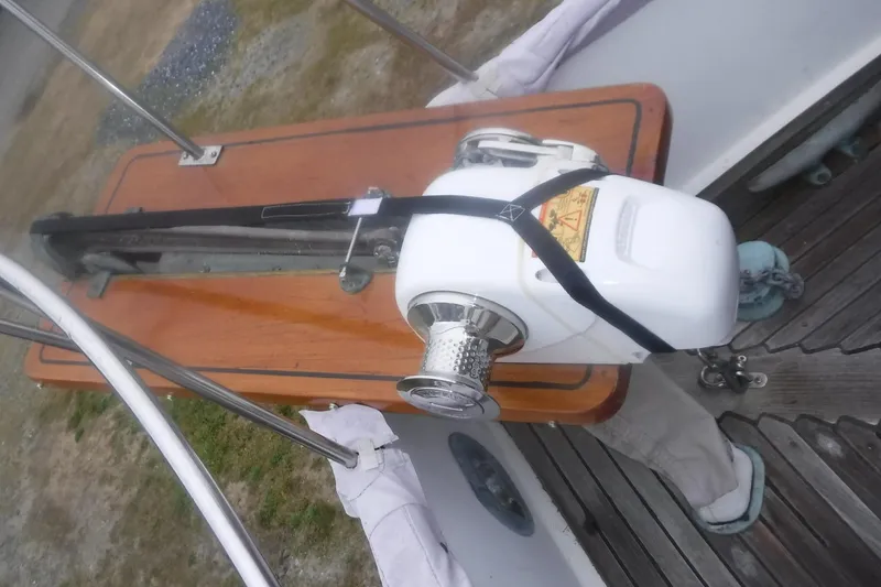 Slide: The Image of Windlass on 1983 Grand Banks 36 Classic boat deck, featuring wooden and metal elements. - 16