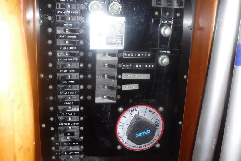 Slide: The Image of Control panel of a 1983 Grand Banks 36 Classic boat with various switches and dials. - 17