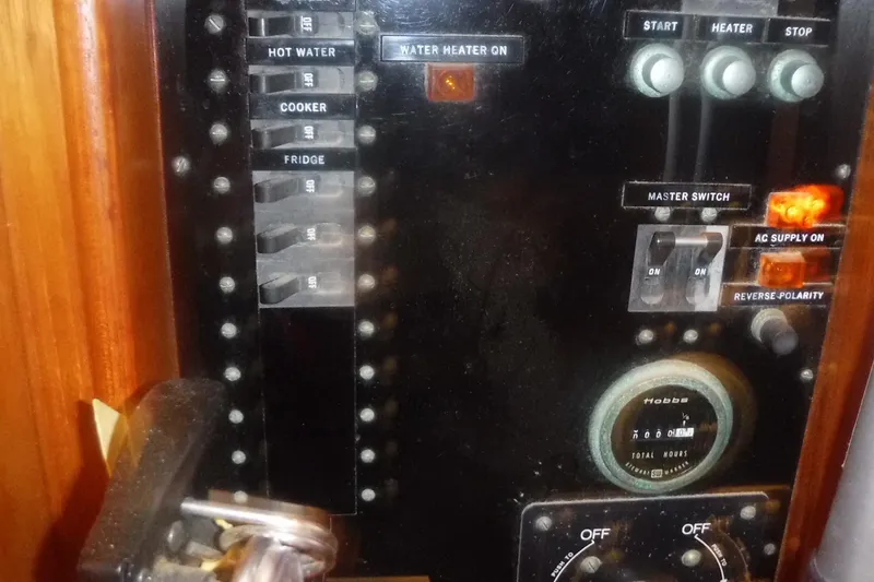 Slide: The Image of Control panel of a 1983 Grand Banks 36 Classic boat, featuring switches and gauges. - 18