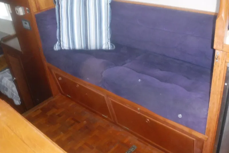 Slide: The Image of Interior of 1983 Grand Banks 36 Classic with purple seating and striped cushion. - 24