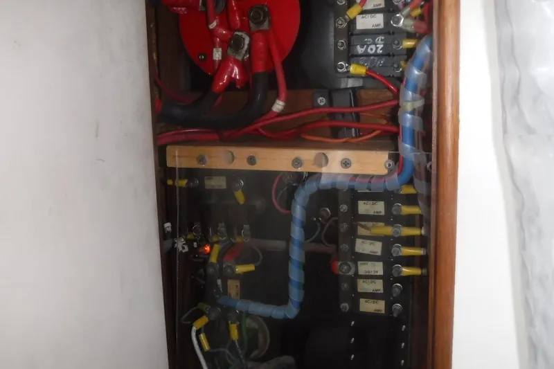 Slide: The Image of Electrical panel of a 1983 Grand Banks 36 Classic boat with wiring and circuit breakers. - 26