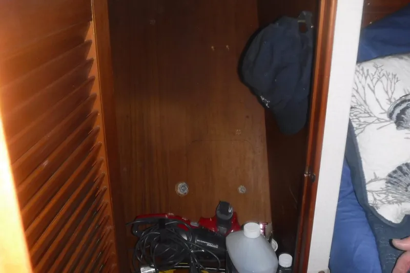 Slide: The Image of Interior storage space on a 1983 Grand Banks 36 Classic boat with various items. - 27