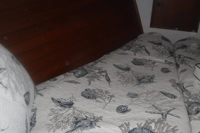Slide: The Image of Cozy cabin bed with nautical-themed bedding on 1983 Grand Banks 36 Classic yacht. - 30