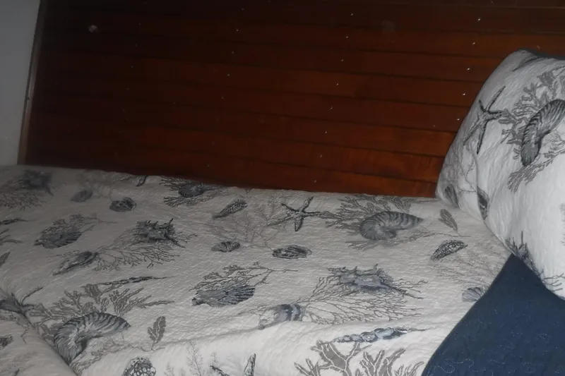 Slide: The Image of Cozy cabin bed with nautical-themed bedding on 1983 Grand Banks 36 Classic yacht. - 31