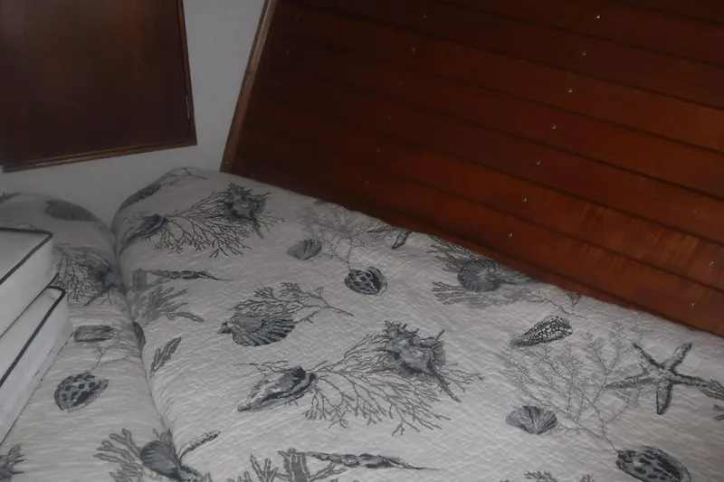 Slide: The Image of Cozy cabin bed with nautical-themed bedding in 1983 Grand Banks 36 Classic yacht. - 32