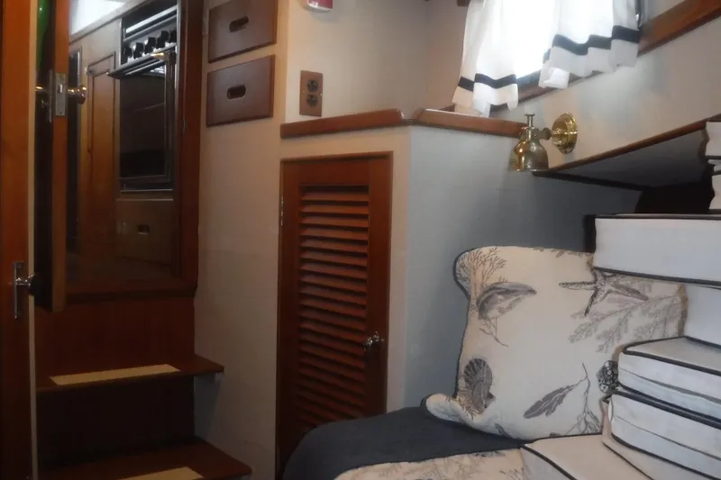 Slide: The Image of Interior of 1983 Grand Banks 36 Classic yacht with wooden stairs and nautical decor. - 33