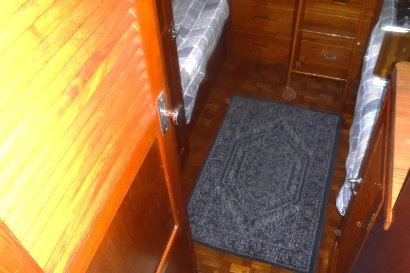 Slide: The Image of Interior of 1983 Grand Banks 36 Classic with wooden cabinetry and patterned rug. - 35