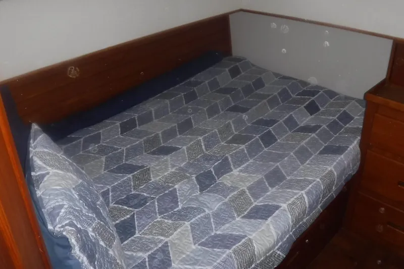 Slide: The Image of Cozy cabin bed with geometric quilt on 1983 Grand Banks 36 Classic yacht. - 39