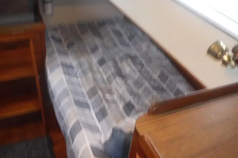 Slide: The Image of Cozy cabin bed with plaid bedding in 1983 Grand Banks 36 Classic yacht. - 40