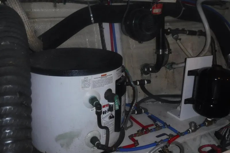 Slide: The Image of Engine room of 1983 Grand Banks 36 Classic with plumbing and equipment. - 49
