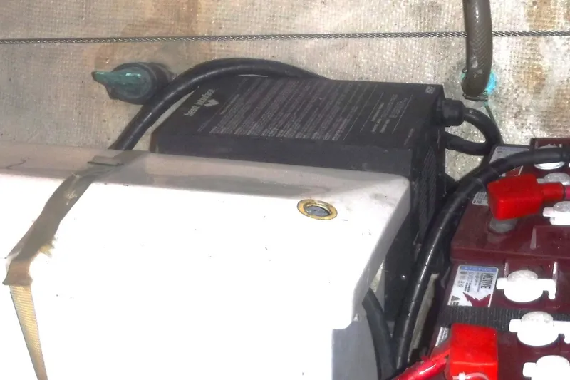 Slide: The Image of Battery compartment of 1983 Grand Banks 36 Classic boat with wiring and connections. - 54