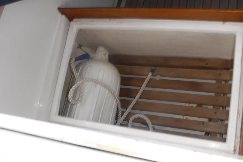 Slide: The Image of Storage compartment on 1983 Grand Banks 36 Classic boat with rope and container. - 8