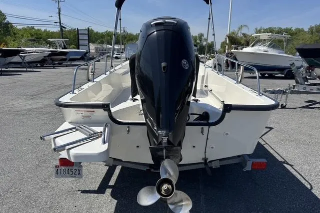 Slide: The Image of 2017 Boston Whaler 170 Montauk boat with outboard motor, parked in a marina. - 10